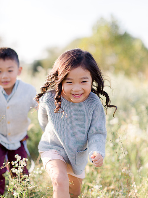 Little kids running in a field
