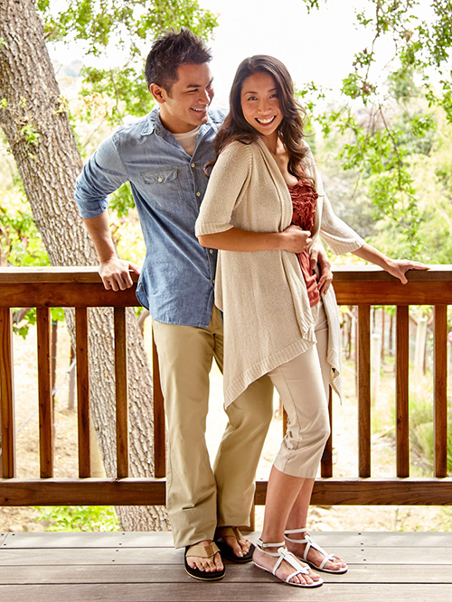 Young couple smiling standing on a deck